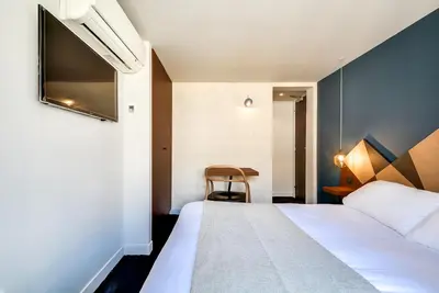 Un ou plusieurs lits dans un hébergement de l'établissement WIT Hotel