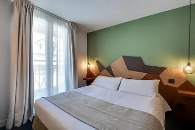 Un ou plusieurs lits dans un hébergement de l'établissement WIT Hotel