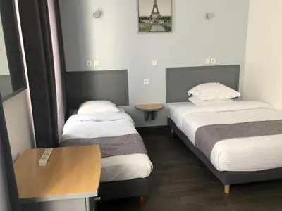 Un ou plusieurs lits dans un hébergement de l'établissement Hôtel Clauzel Paris