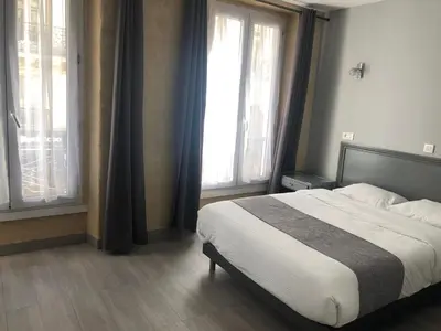 Un ou plusieurs lits dans un hébergement de l'établissement Hôtel Clauzel Paris