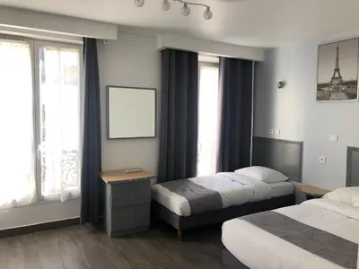 Un ou plusieurs lits dans un hébergement de l'établissement Hôtel Clauzel Paris