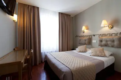 Un ou plusieurs lits dans un hébergement de l'établissement Cosmotel Hotel
