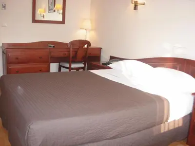 Un ou plusieurs lits dans un hébergement de l'établissement Cosmotel Hotel