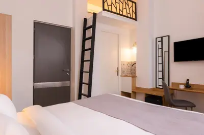 Un ou plusieurs lits dans un hébergement de l'établissement Hotel Terre Neuve