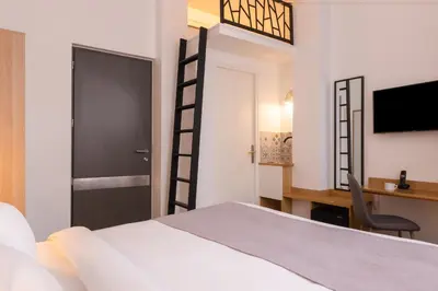Un ou plusieurs lits dans un hébergement de l'établissement Hotel Terre Neuve