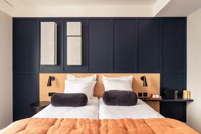 Un ou plusieurs lits dans un hébergement de l'établissement Hôtel Maison Traversière