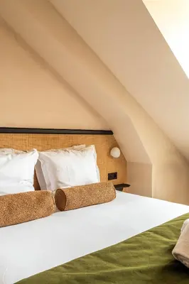 Un ou plusieurs lits dans un hébergement de l'établissement Hôtel Maison Traversière