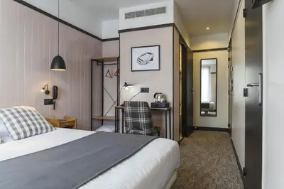 Un ou plusieurs lits dans un hébergement de l'établissement Hotel SUB