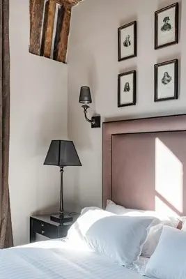 Un ou plusieurs lits dans un hébergement de l'établissement Hôtel Le Presbytère