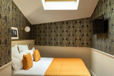 Un ou plusieurs lits dans un hébergement de l'établissement Hôtel Léna