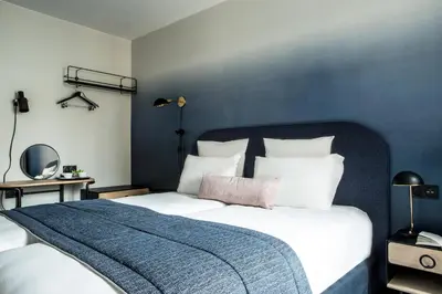 Un ou plusieurs lits dans un hébergement de l'établissement L'Imprimerie Hôtel