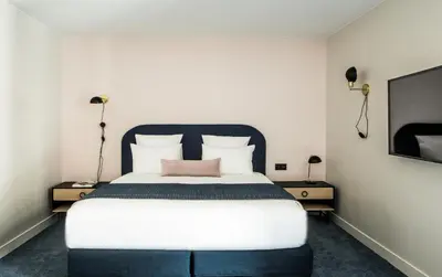 Un ou plusieurs lits dans un hébergement de l'établissement L'Imprimerie Hôtel