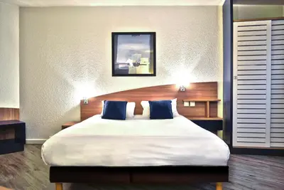 Un ou plusieurs lits dans un hébergement de l'établissement Art Hotel Paris Est