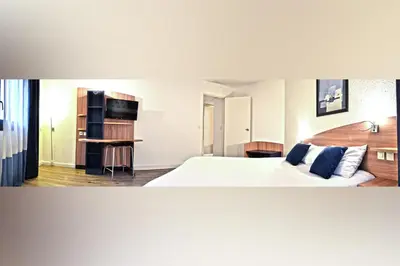 Un ou plusieurs lits dans un hébergement de l'établissement Art Hotel Paris Est