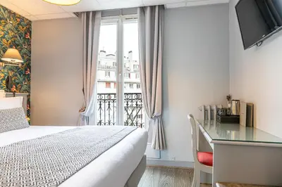 Un ou plusieurs lits dans un hébergement de l'établissement Splendid Hôtel