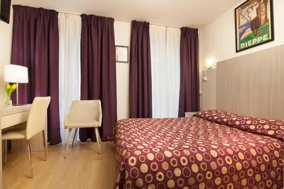 Un ou plusieurs lits dans un hébergement de l'établissement Hotel Excelsior