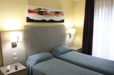 Un ou plusieurs lits dans un hébergement de l'établissement Hotel Excelsior