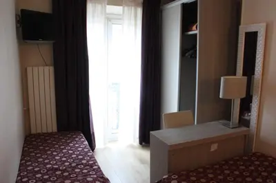 Un ou plusieurs lits dans un hébergement de l'établissement Hotel Excelsior