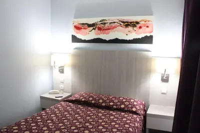 Un ou plusieurs lits dans un hébergement de l'établissement Hotel Excelsior