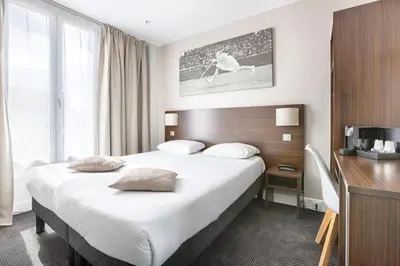 Un ou plusieurs lits dans un hébergement de l'établissement Hotel De Paris
