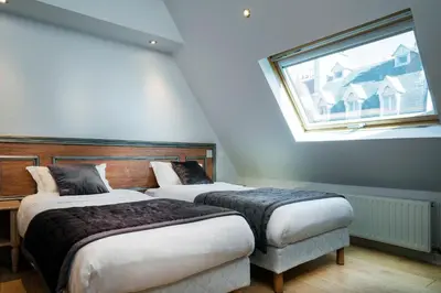Un ou plusieurs lits dans un hébergement de l'établissement Hôtel Du Brésil
