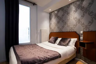 Un ou plusieurs lits dans un hébergement de l'établissement Hôtel Du Brésil