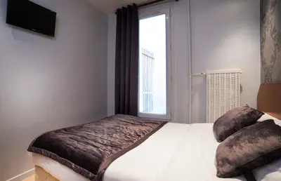 Un ou plusieurs lits dans un hébergement de l'établissement Hôtel Du Brésil
