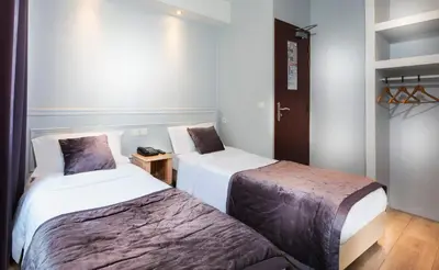 Un ou plusieurs lits dans un hébergement de l'établissement Hôtel Du Brésil