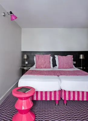 Un ou plusieurs lits dans un hébergement de l'établissement Hotel Antin Trinité