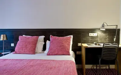Un ou plusieurs lits dans un hébergement de l'établissement Hotel Antin Trinité