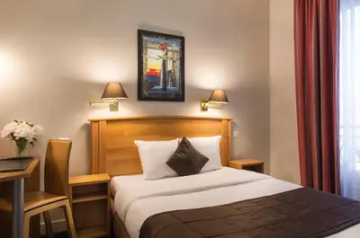 Un ou plusieurs lits dans un hébergement de l'établissement Hotel Corona -Rodier-