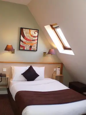 Un ou plusieurs lits dans un hébergement de l'établissement Hotel Corona -Rodier-