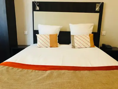 Un ou plusieurs lits dans un hébergement de l'établissement Hotel Corona -Rodier-
