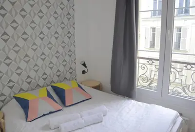 Un ou plusieurs lits dans un hébergement de l'établissement Longchamp Apartment
