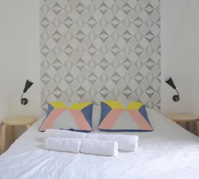 Un ou plusieurs lits dans un hébergement de l'établissement Longchamp Apartment