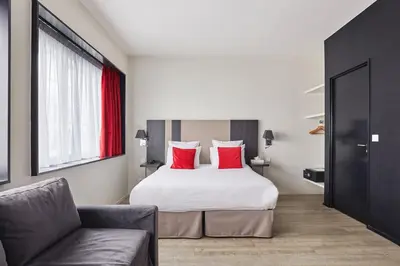 Un ou plusieurs lits dans un hébergement de l'établissement Appart'hôtel Odalys City - Paris XVII