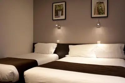 Un ou plusieurs lits dans un hébergement de l'établissement Hotel Cosmos