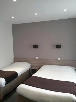 Un ou plusieurs lits dans un hébergement de l'établissement Hotel Cosmos