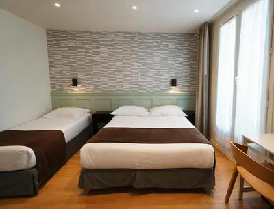 Un ou plusieurs lits dans un hébergement de l'établissement Hotel Cosmos
