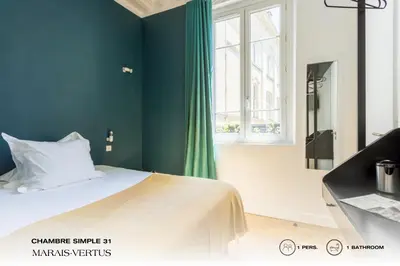 Un ou plusieurs lits dans un hébergement de l'établissement Beauquartier - Marais Vertus