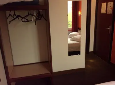 Un ou plusieurs lits dans un hébergement de l'établissement Hotel De La Place