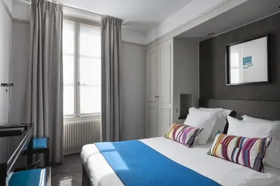 Un ou plusieurs lits dans un hébergement de l'établissement Hôtel Duo