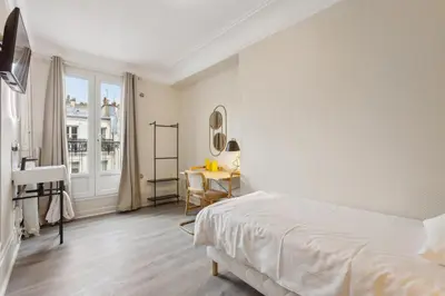 Un ou plusieurs lits dans un hébergement de l'établissement Hôtel Juliette