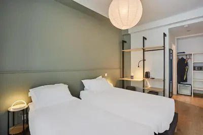 Un ou plusieurs lits dans un hébergement de l'établissement Hôtel Beauquartier Montmartre