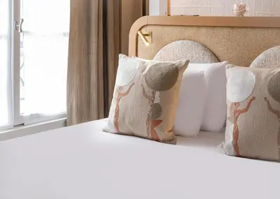 Un ou plusieurs lits dans un hébergement de l'établissement Hôtel Le Monna Lisa by Inwood Hotels