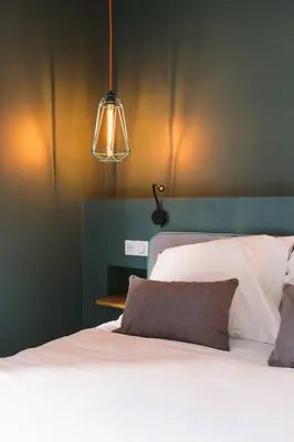 Un ou plusieurs lits dans un hébergement de l'établissement Le Petit Cosy Hôtel