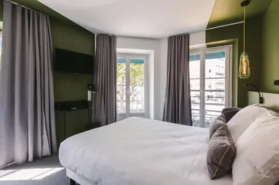 Un ou plusieurs lits dans un hébergement de l'établissement Le Petit Cosy Hôtel
