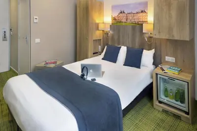 Un ou plusieurs lits dans un hébergement de l'établissement Hôtel Eugénie
