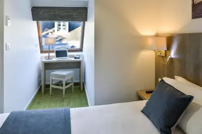 Un ou plusieurs lits dans un hébergement de l'établissement Hôtel Eugénie