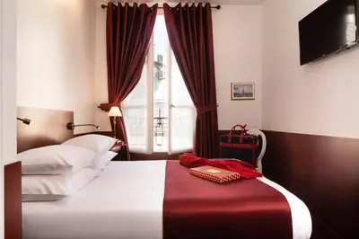 Un ou plusieurs lits dans un hébergement de l'établissement Odeon Hotel